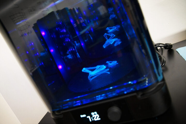 A 3D printer creates a plastic piece.