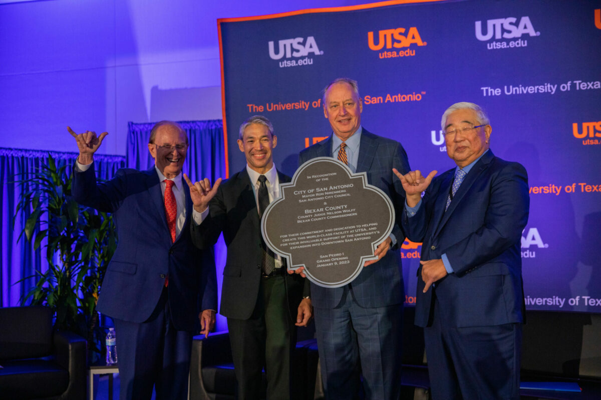 Former Bexar County Judge Nelson Wolff, San Antonio Mayor Ron Nirenberg, UTSA President Taylor Eighmy and Bexat County Judge Peter Sakai stand beside each other on stage during the San Pedro I opening.