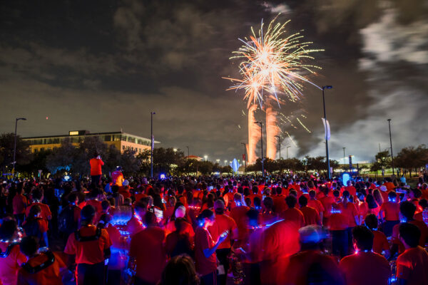 Hundreds of students watch a fireworks show near the North Paseo Building.