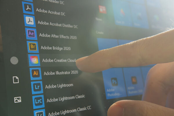 A user selects Adobe Creative Cloud from a dropdown menu on a tablet screen.