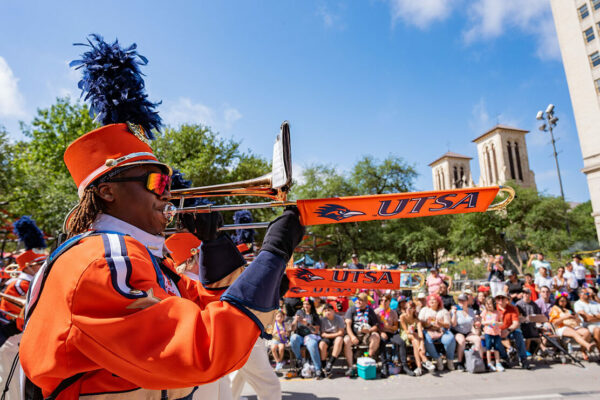 A trombone player marches down the street