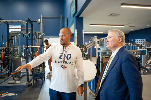 Ryan Filo shows Mike Aresco around the weight room