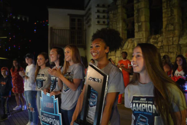 UTSA soccer players look out at a large crowd