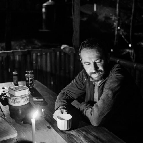 Michael Cepek drinking from a mug at a table