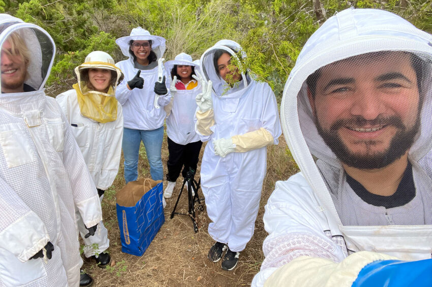 Ferhat Ozturk and his students pose for a photo in their apiary gear