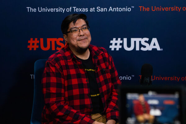 Cody Cly smiles for the camera in the Planet UTSA studio