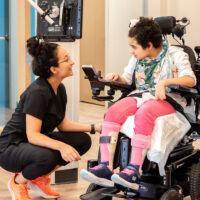 A person looks down at her physician.