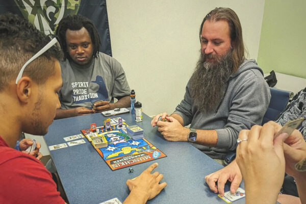 William Lansdon plays a card game with five other veterans