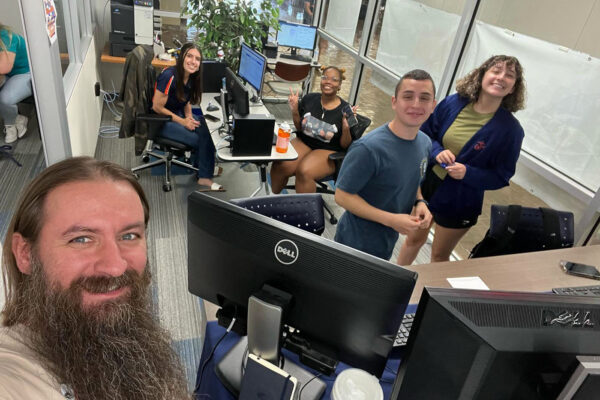 William Lansdon takes a selfie with four students