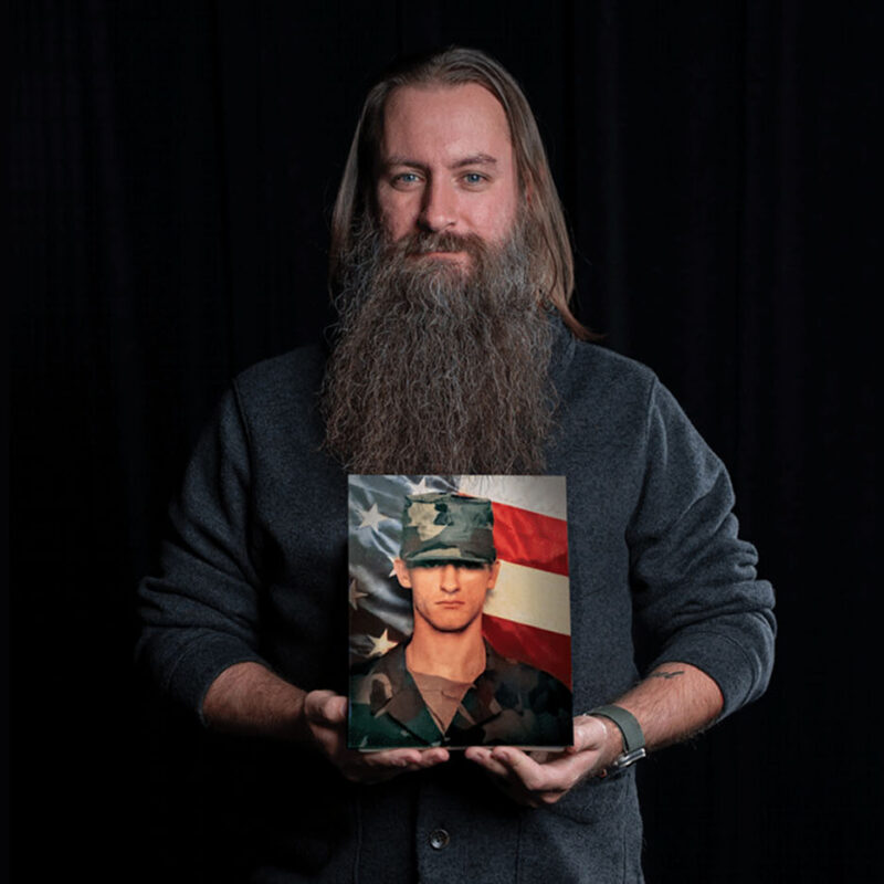 UTSA's William Lansdon holds a photo of himself from Basic Training