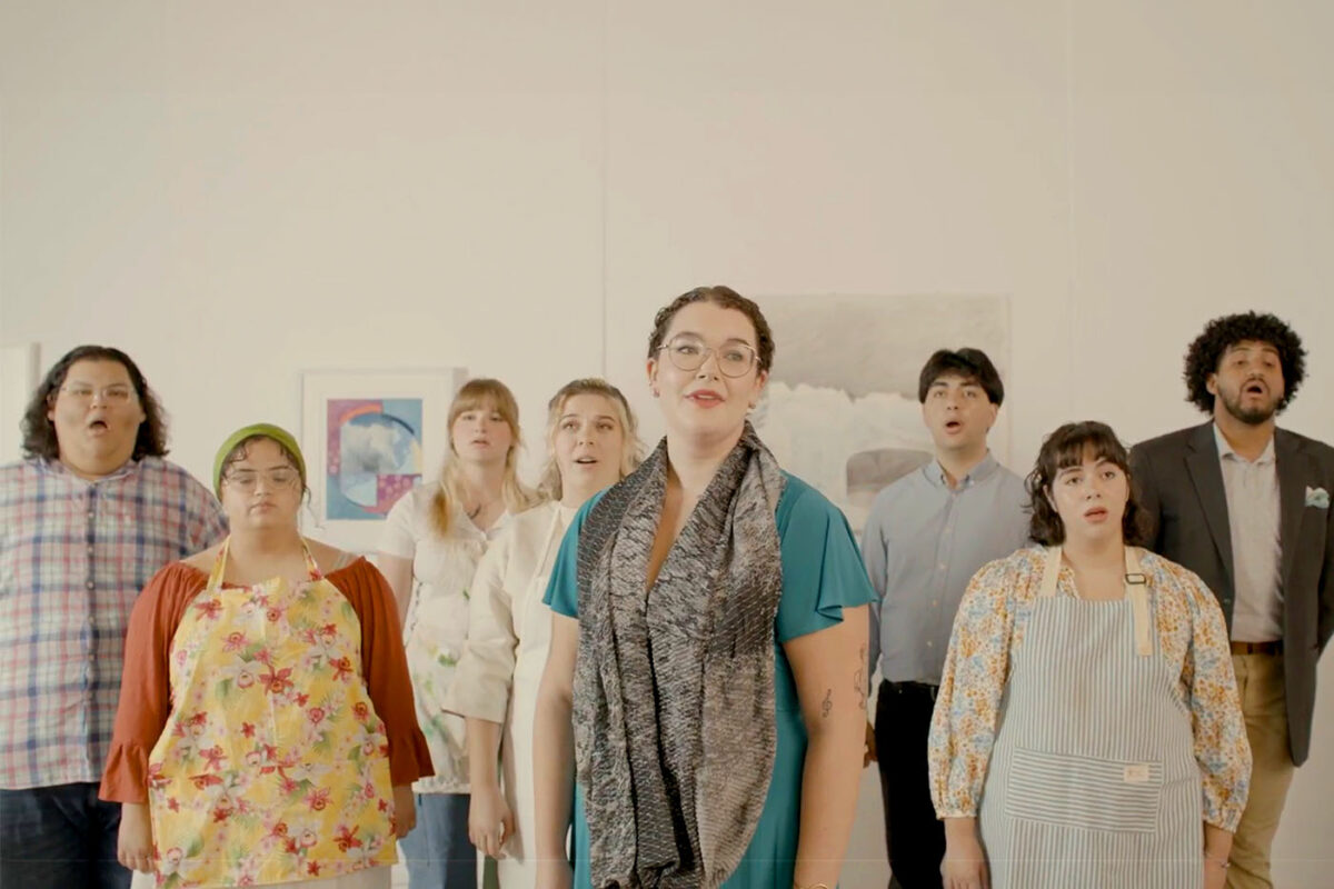 Eight opera singers sing in an art gallery