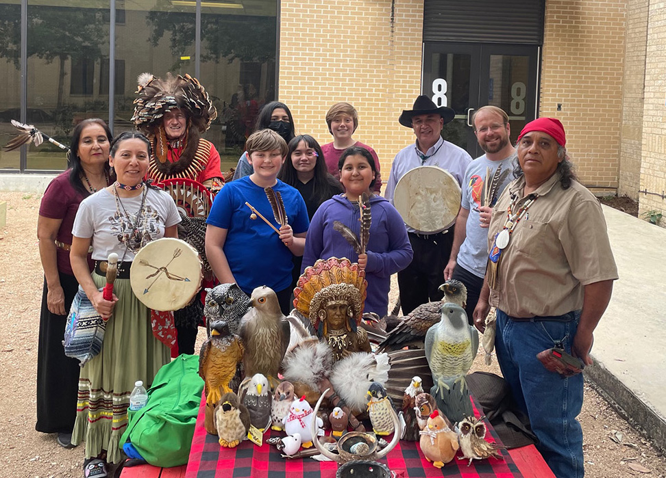 Students pose for a photo with an indigenous group.