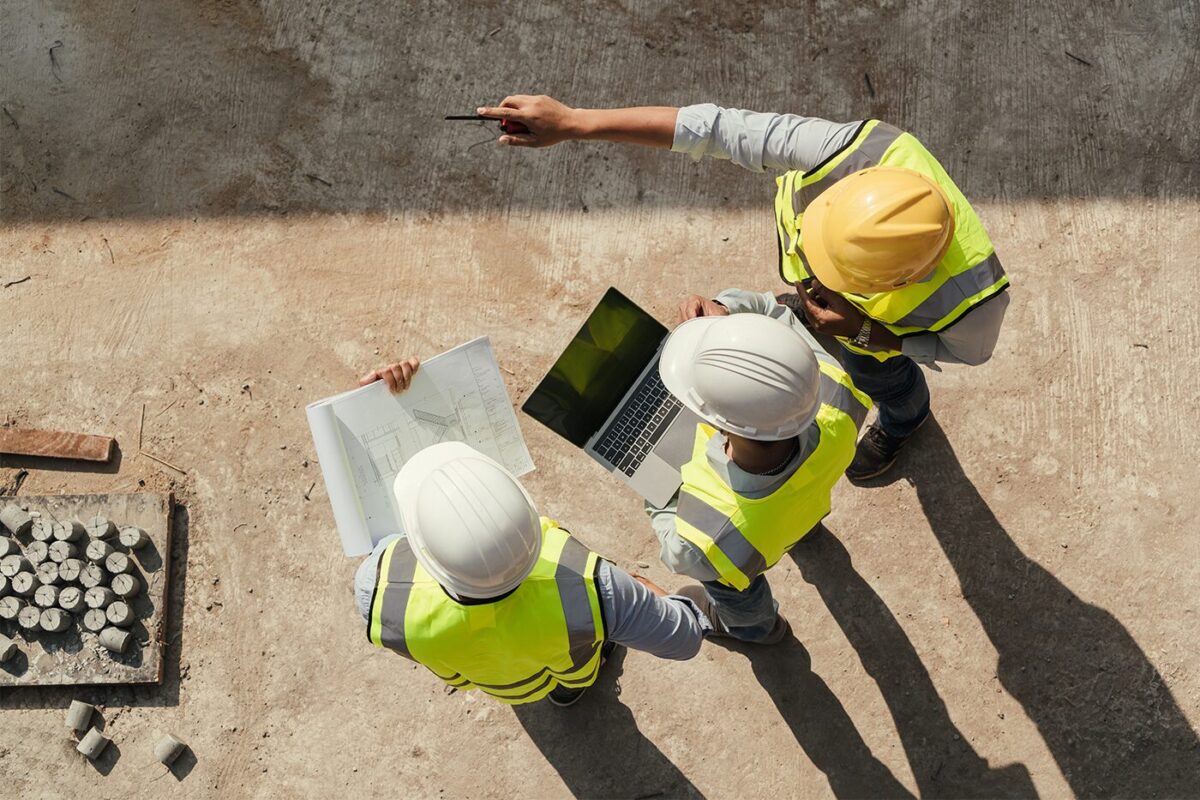 Construction managers compare notes on a job site