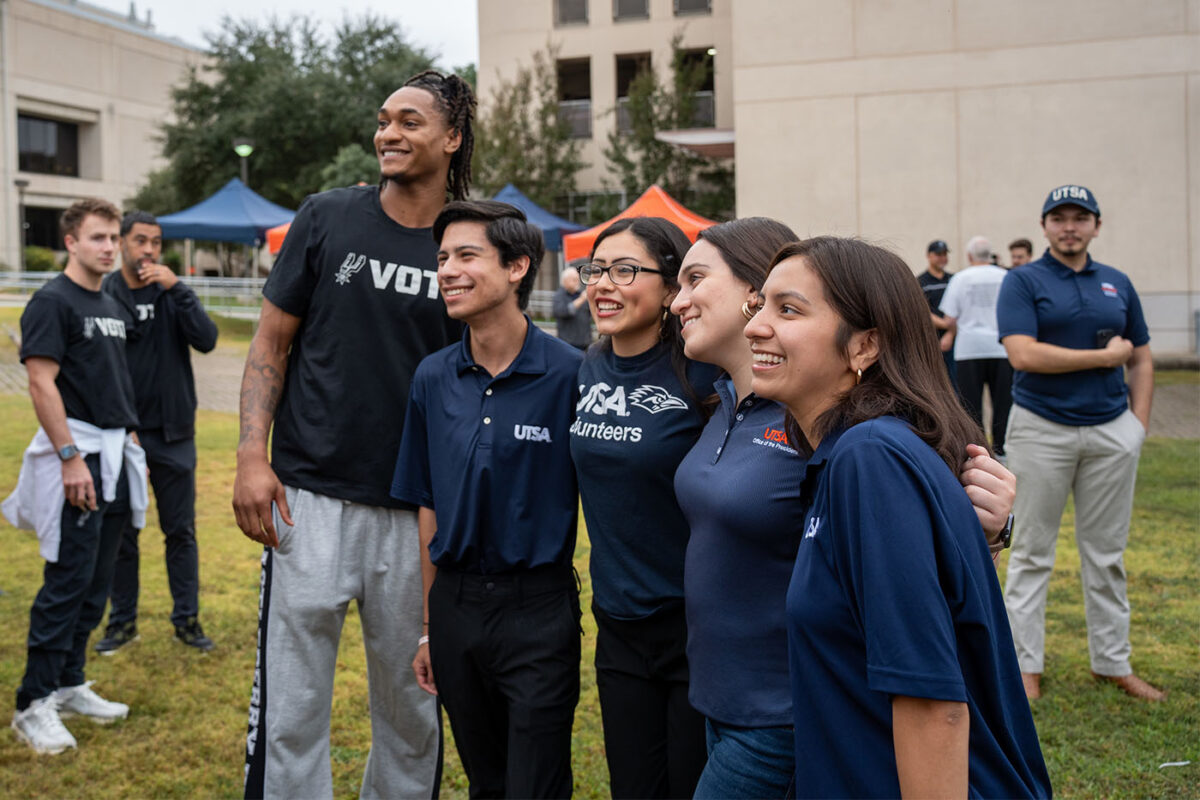 Devin Vassell posed for a photo with four delighted fans.