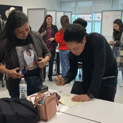 Man signs autographs.