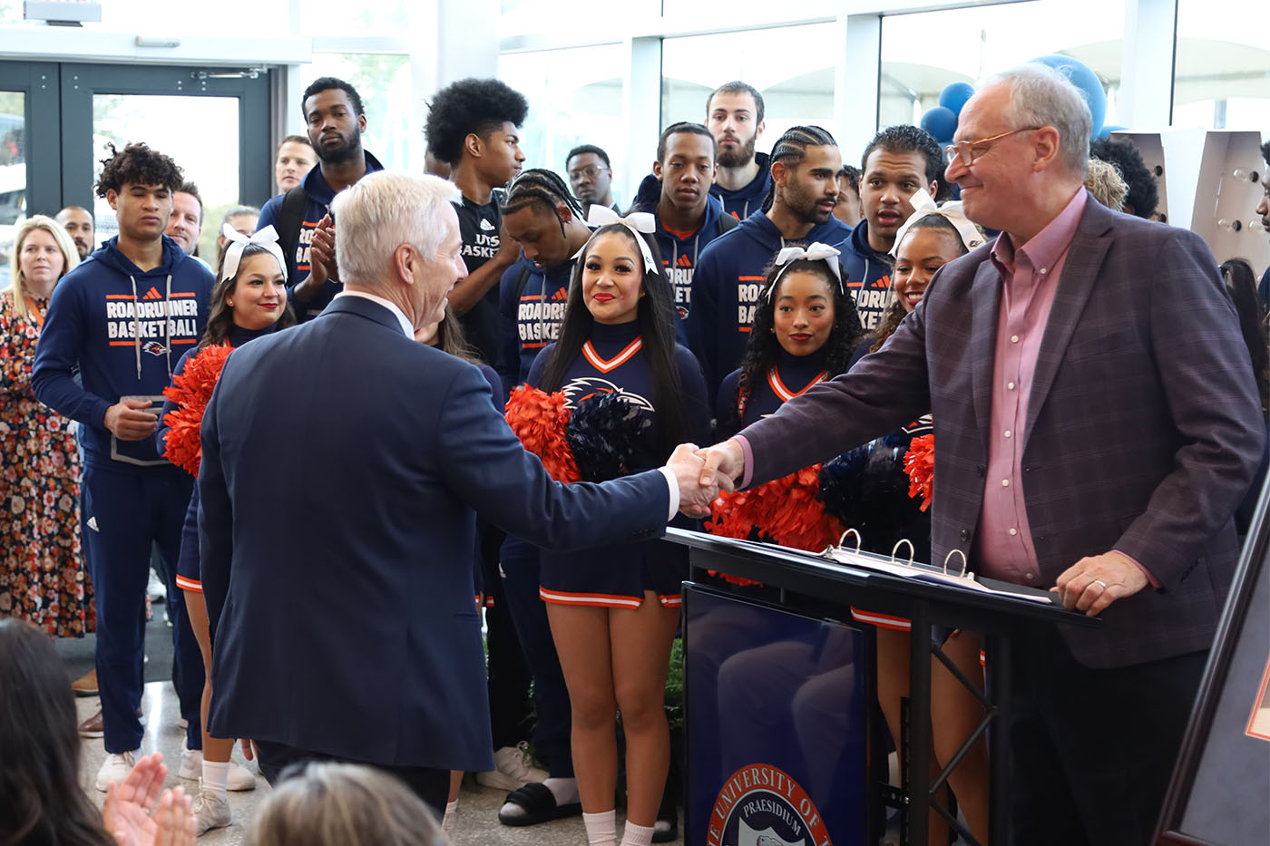 Gene Dawson and Taylor Eighmy shake hands