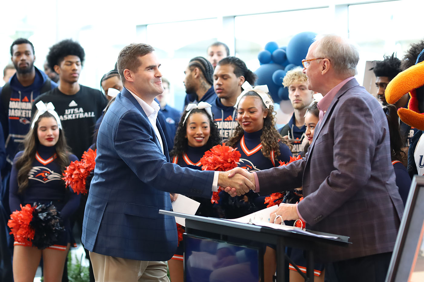 Moody and Eighmy share a handshake at the ceremony