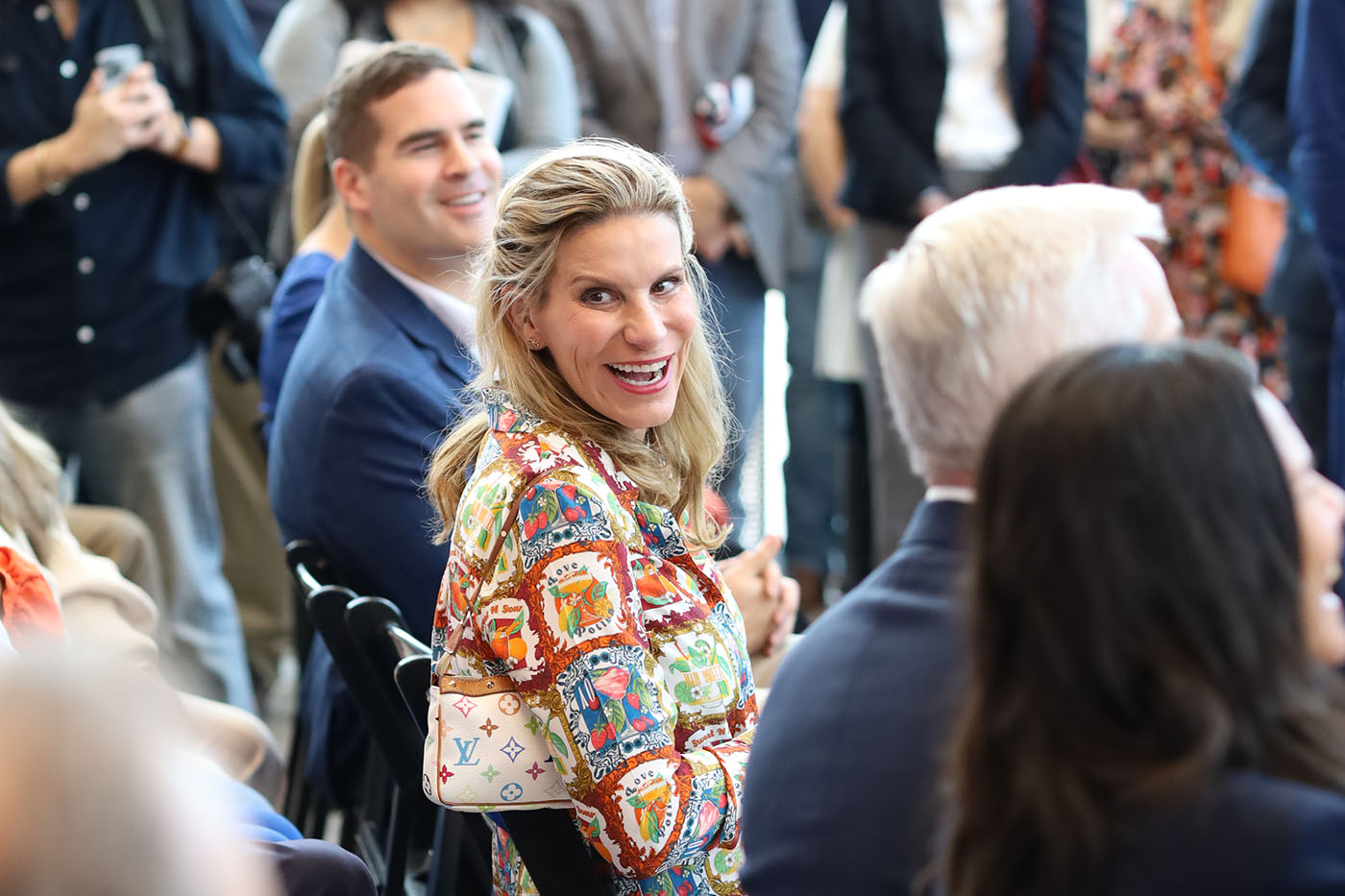 April Ancira laughs from her seat at the groundbreaking ceremony