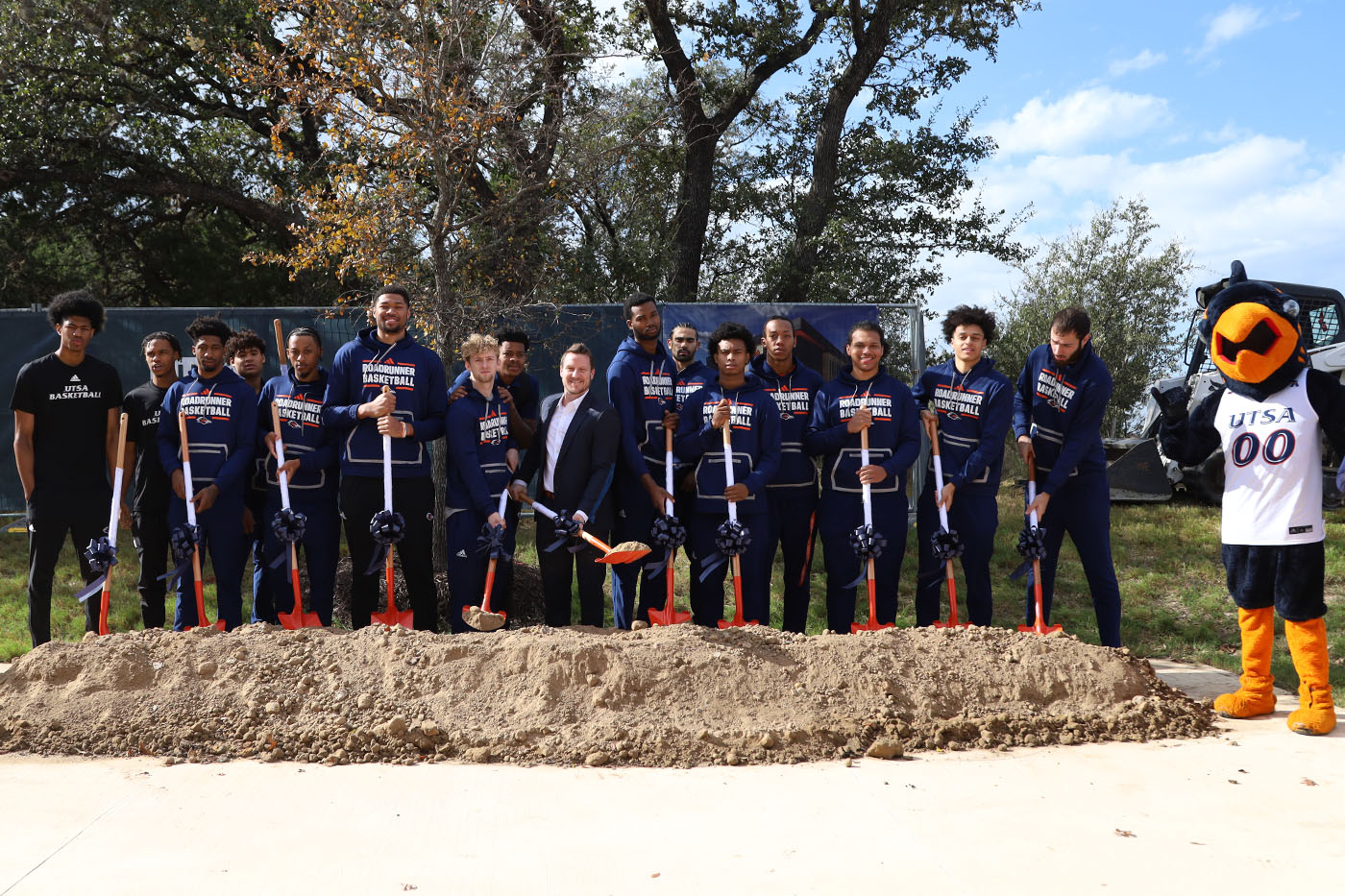 The UTSA men's basketball team puts shovels in a dirt mound