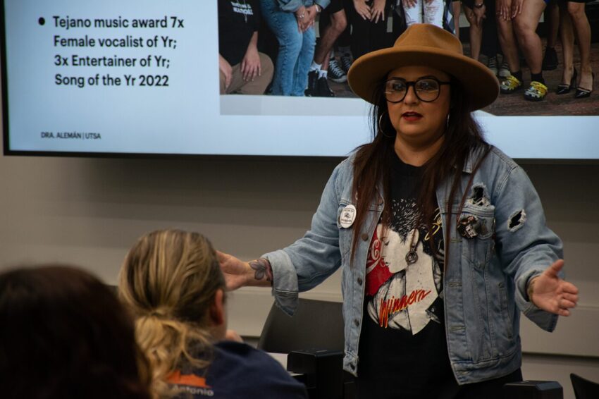 A woman speaking in front of others.