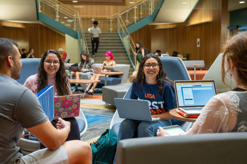 Four students chat at the John Peace Library