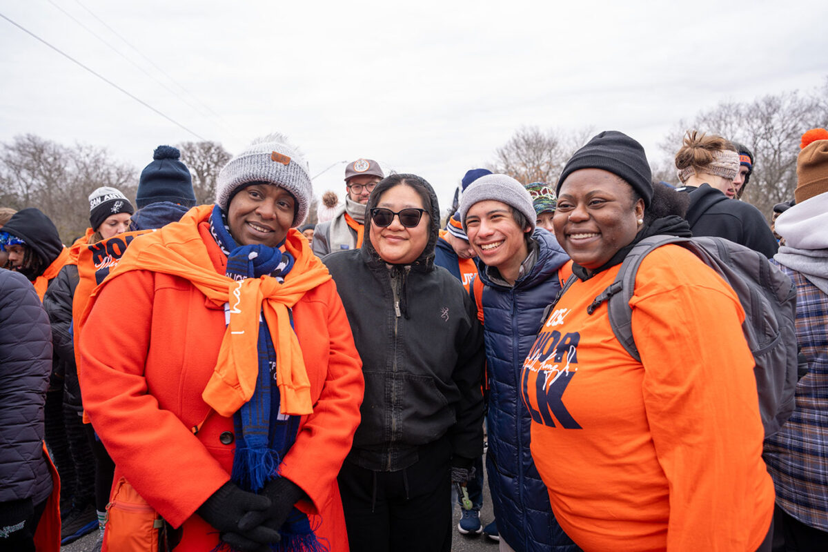 Four woman stand together.