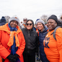 Four woman stand together.