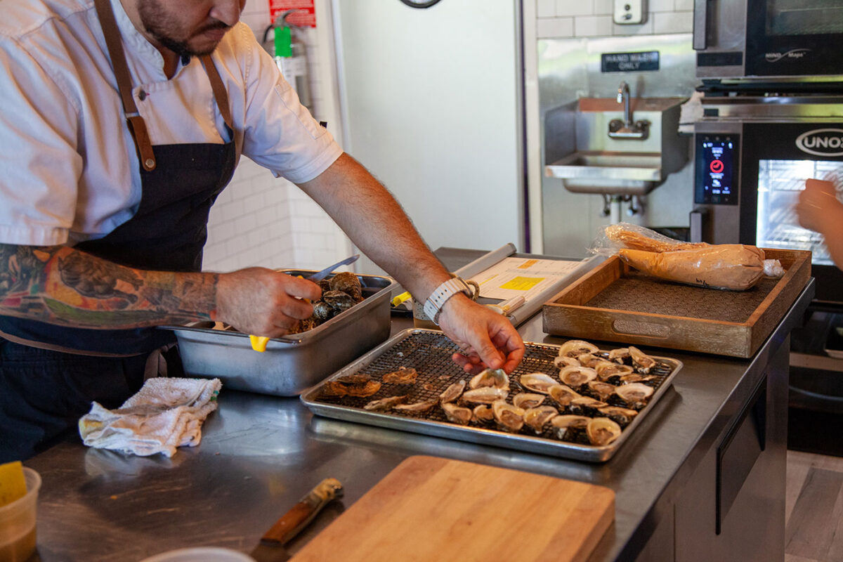 A man places an oyster down.