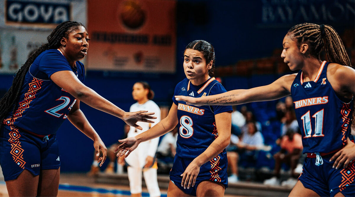 Idara Udo slaps hands with her teammates