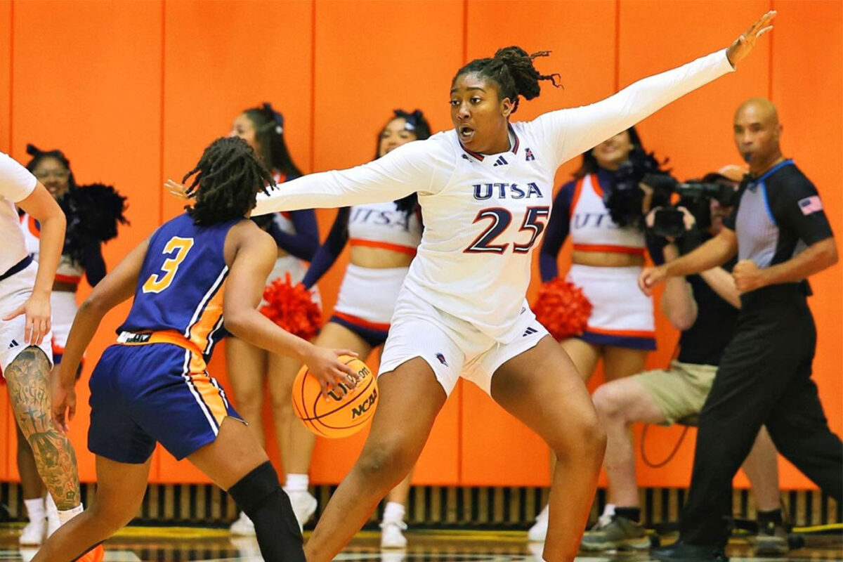 Idara Udo puts up her left hand to defend a potential pass