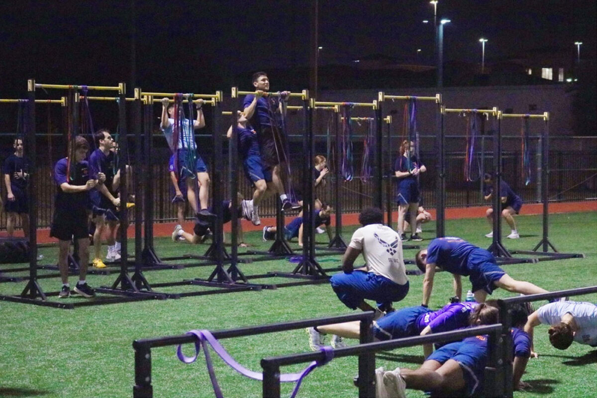 Cadets do pull-ups on bars and push-ups on the field.