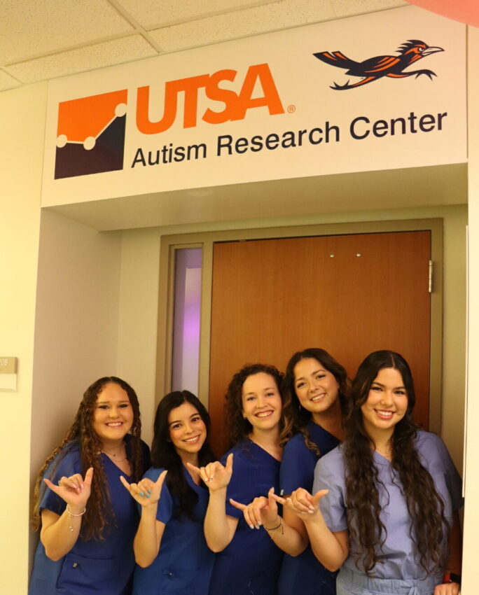 Five women raise their hands to make a gesture