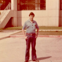 A photo of a man dressed in vintage clothing from the 1980s.
