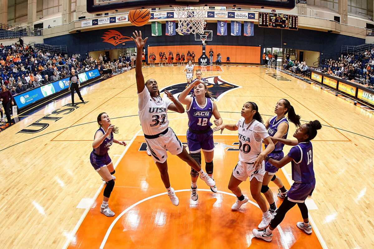 Jenkins outjumps Abilene Christian defenders to score a basket