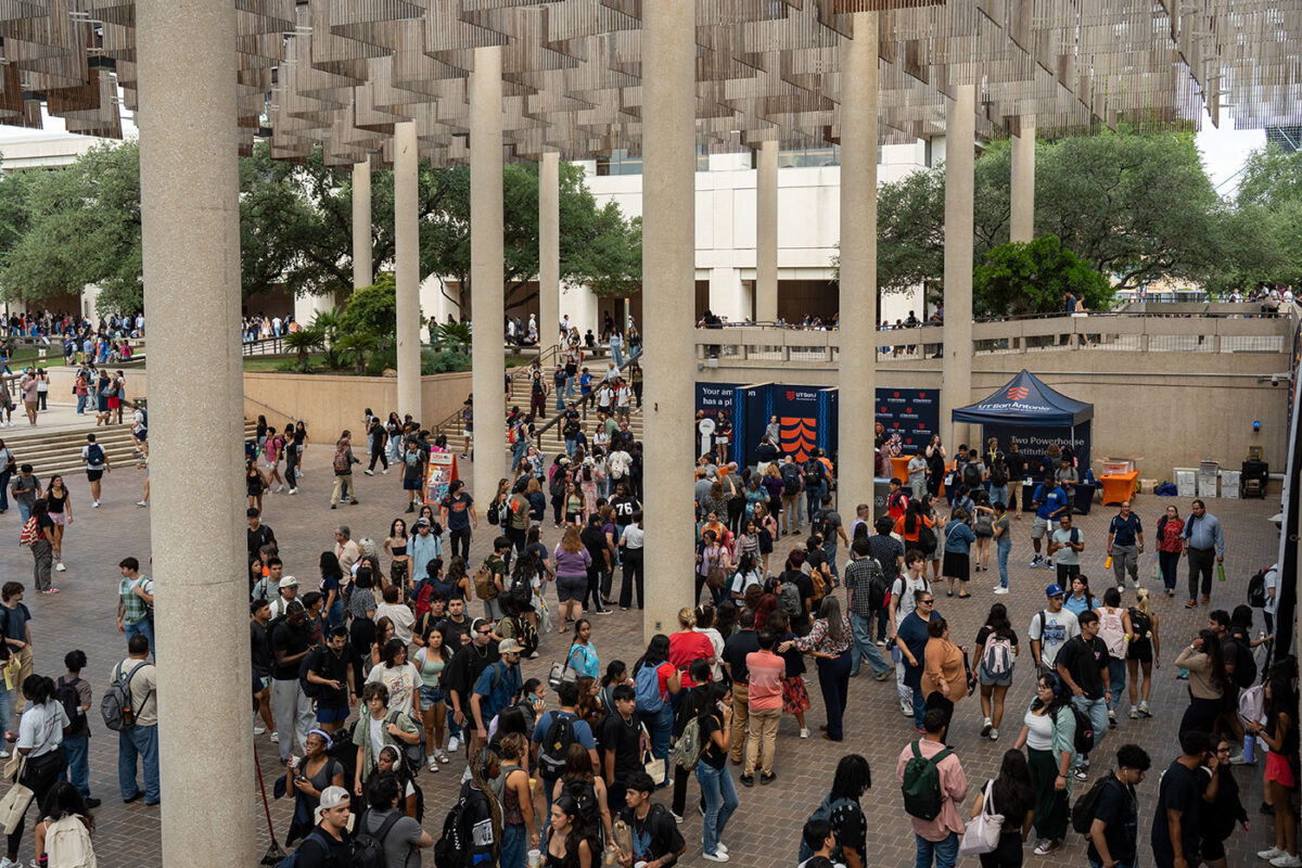 Groups of students line up in an open space.