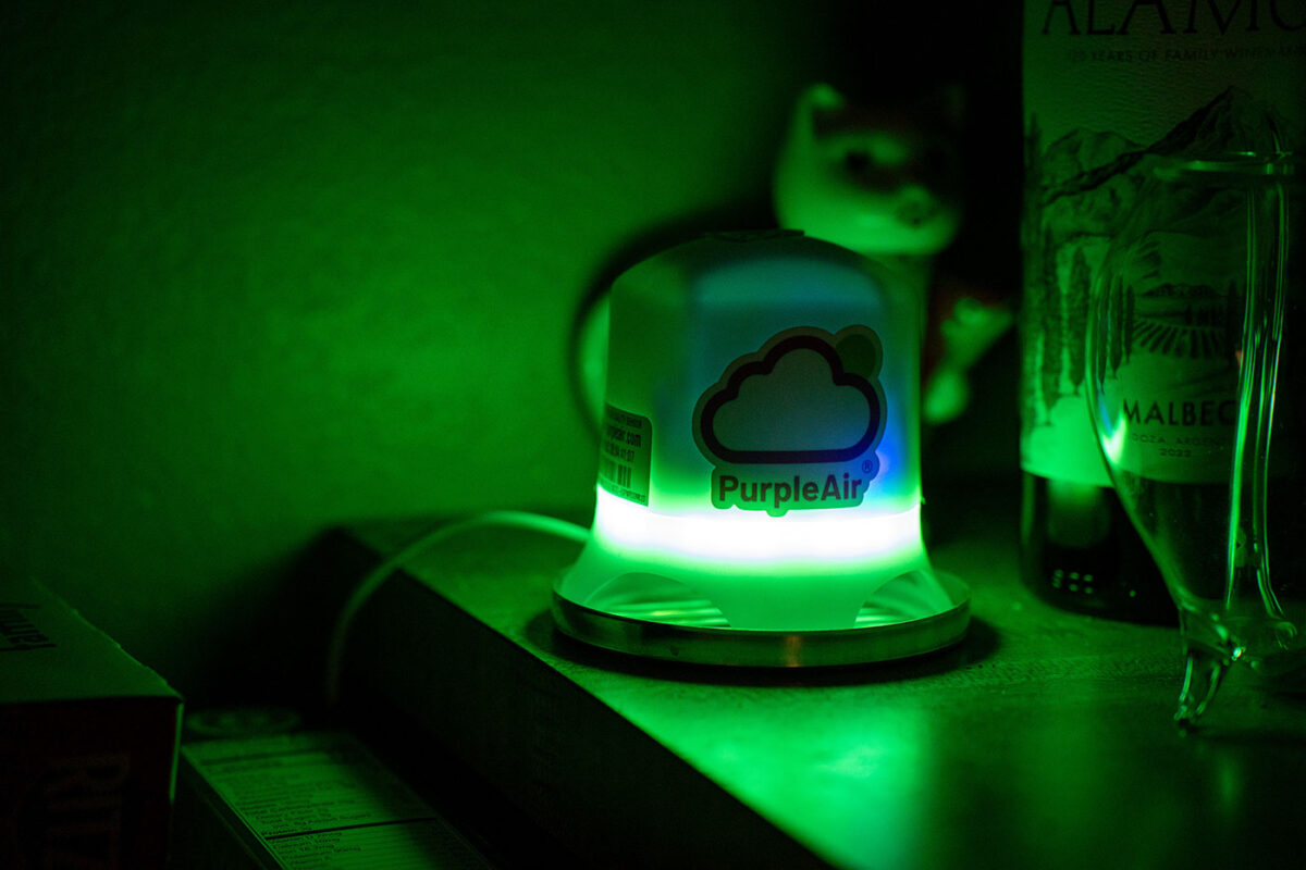 A glowing green device sits on a table.