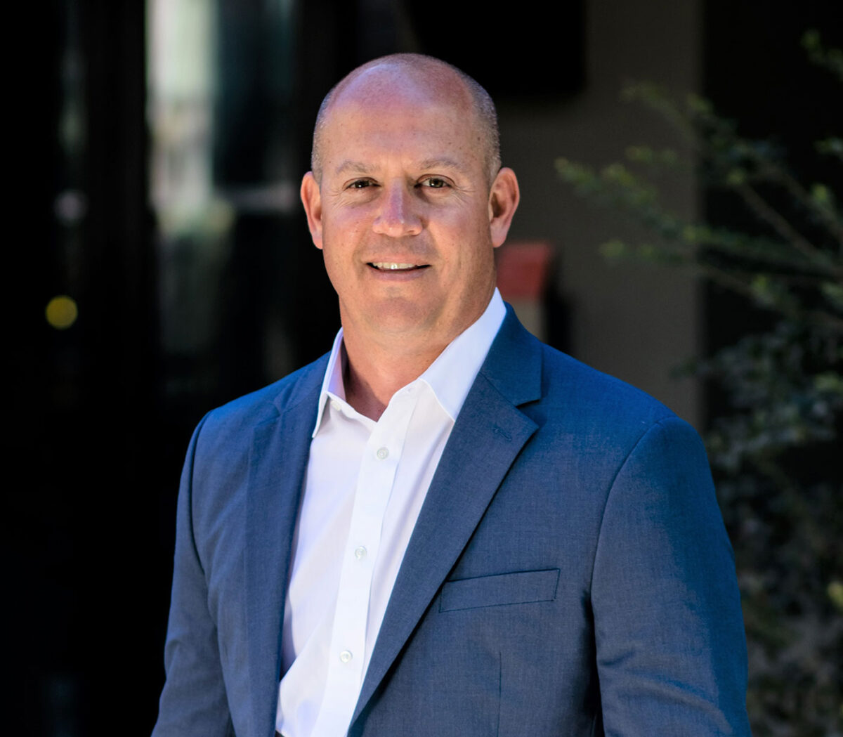 A Man in a blue suit with a white dress shirt.