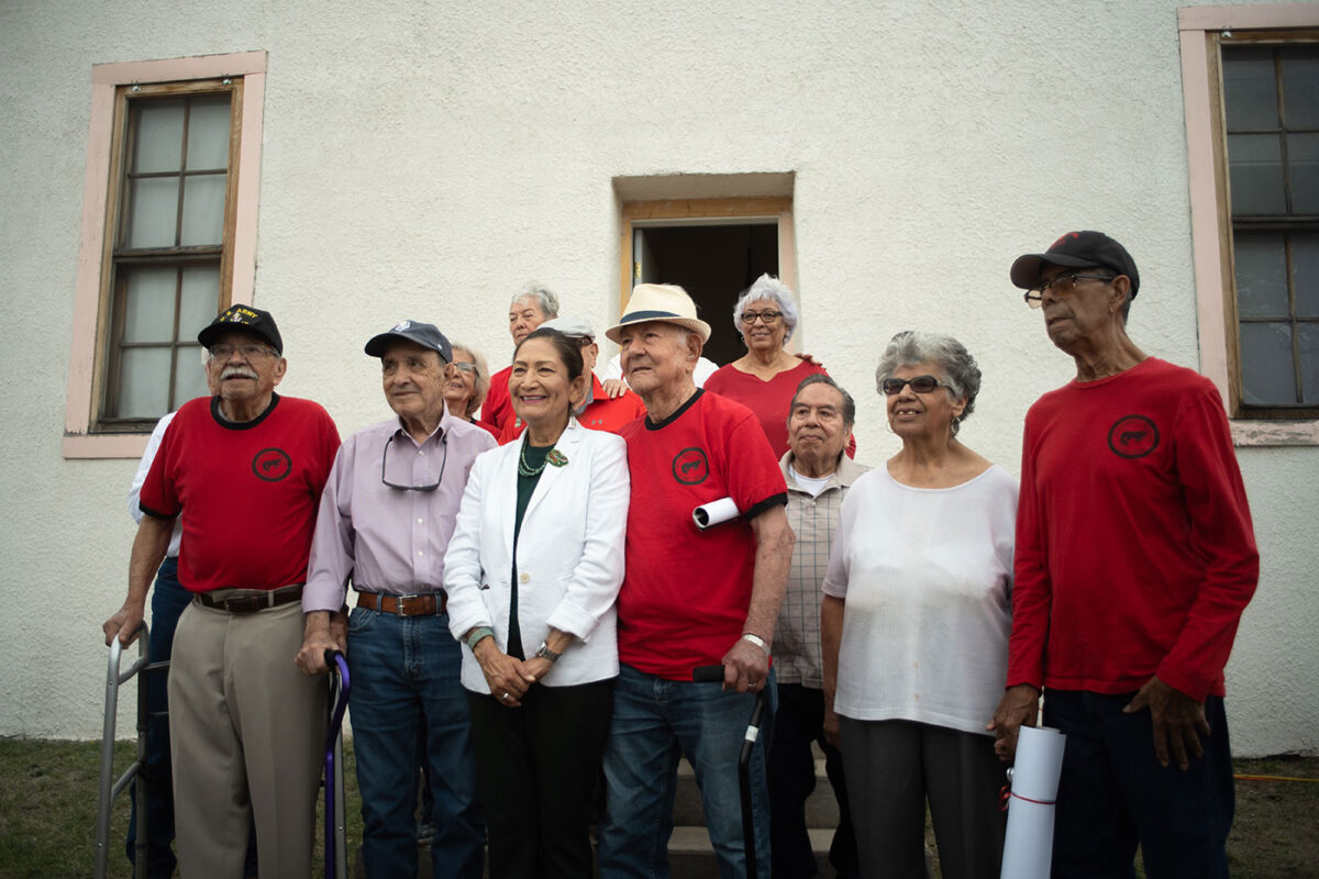 A photo of a group of older individuals with canes. They all look at the camera and smile.