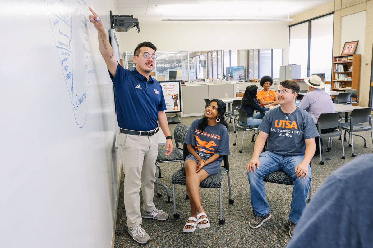 A man stands at a white board