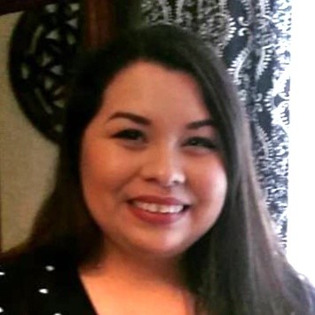 A portrait of a woman with long black hair name Cristina Winston, an exhibit coordinator from the Institute of Texan Cultures.