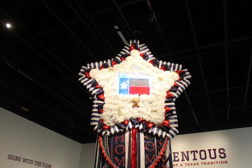 A giant homecoming mum in the shape of a start is suspended from the ceiling at the Institute of Texan Cultures.