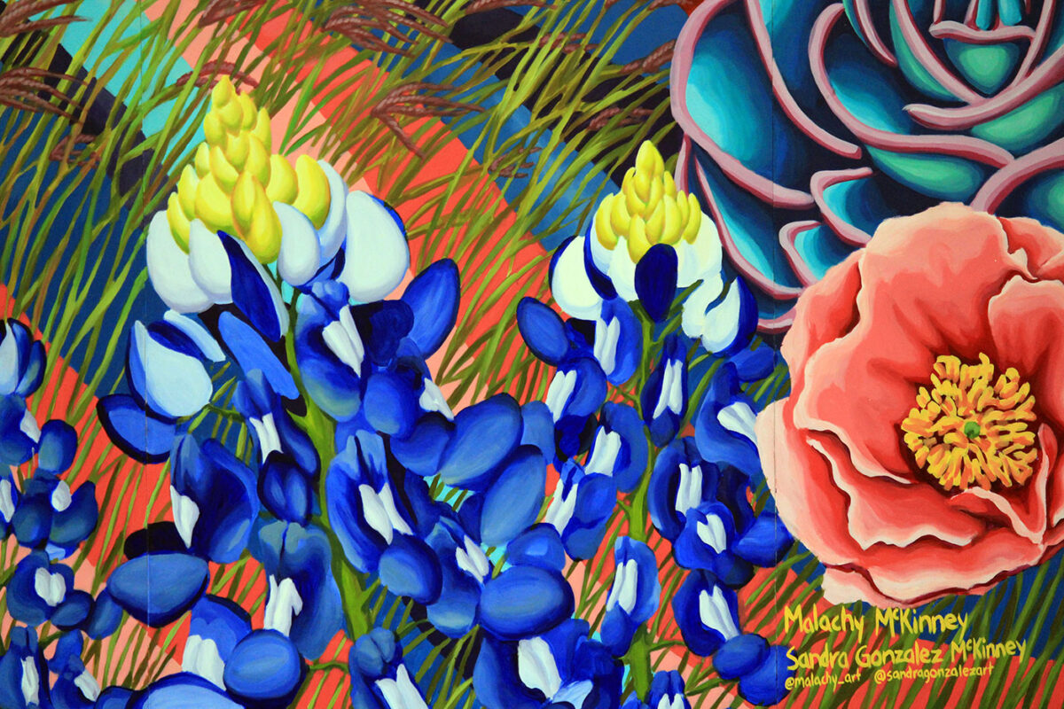 An image of painted bluebonnets and other native plants on display in a mural at the Institute of Texan Cultures.