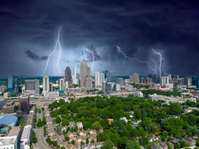 Several lightning strikes emerge over the Atlanta skyline.