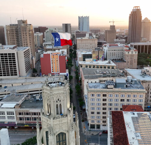 San Antonio skyline with Texas flag waving