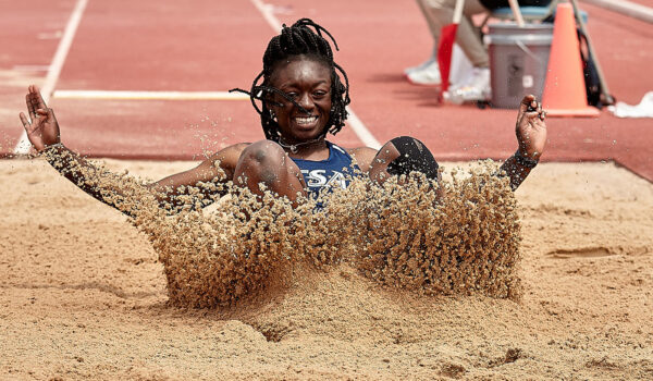 Oreoluwa Adamson lands in the sand during the long jump