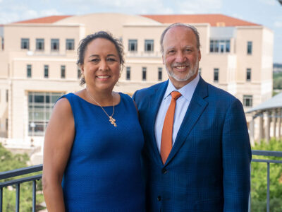 A woman in a blue dress and a man in a blue suit.