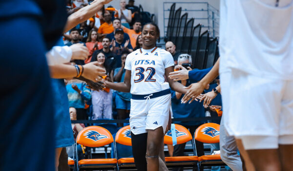 Jenkins slaps hands with her teammates and she walks on the court