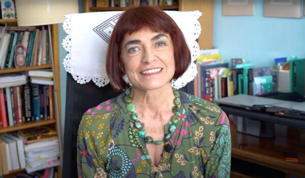 Malgorzata Oleszkiewicz-Peralba smiles from her desk chair