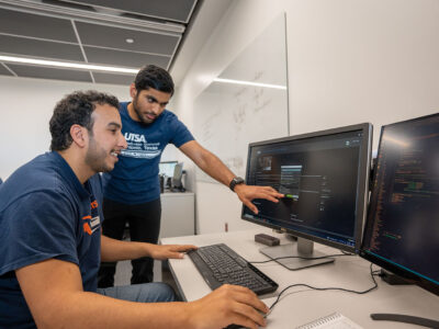 An instructor walks a student through a computer prompt.