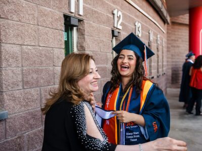 Two women laugh and smile